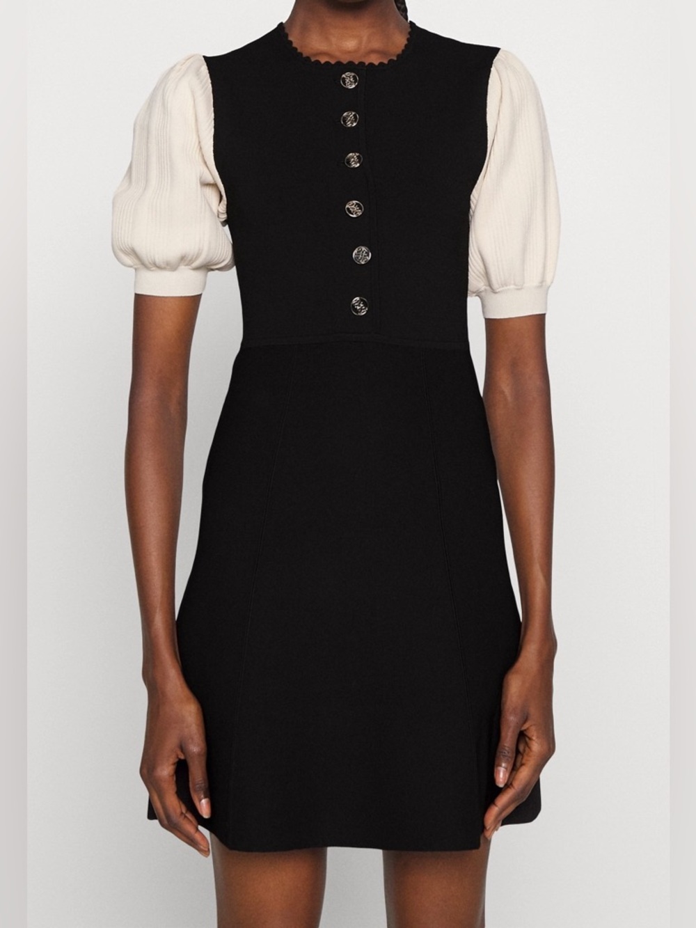 Sandro knitted dress featuring contrasting puff sleeves, a button placket